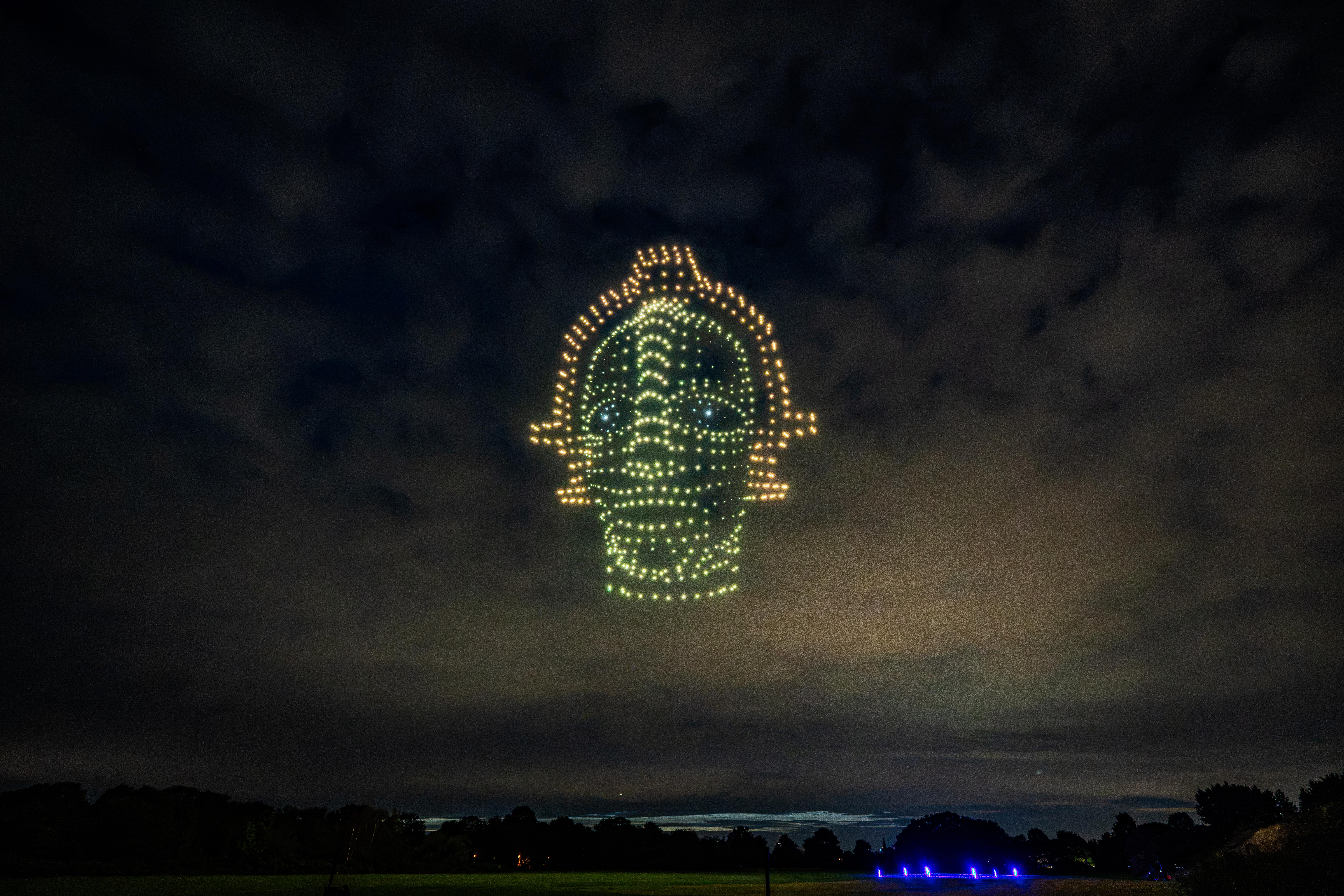 Glowing circular spacecraft formation made of drones above Düsseldorf
